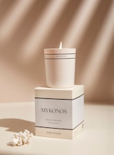 a white candle sitting on top of a box