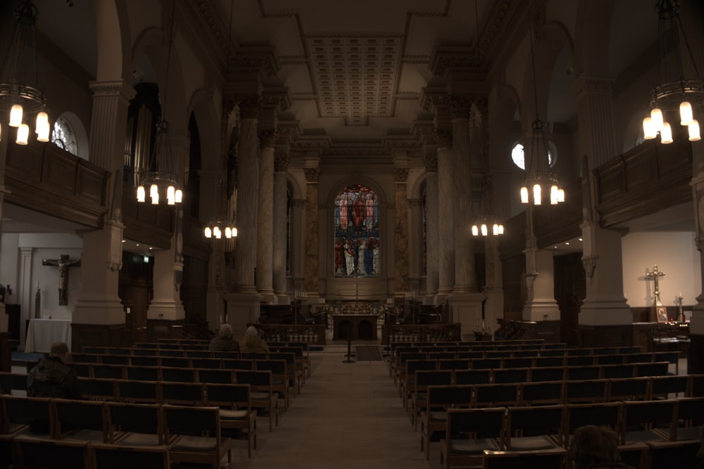 a church filled with pews and a stained glass window