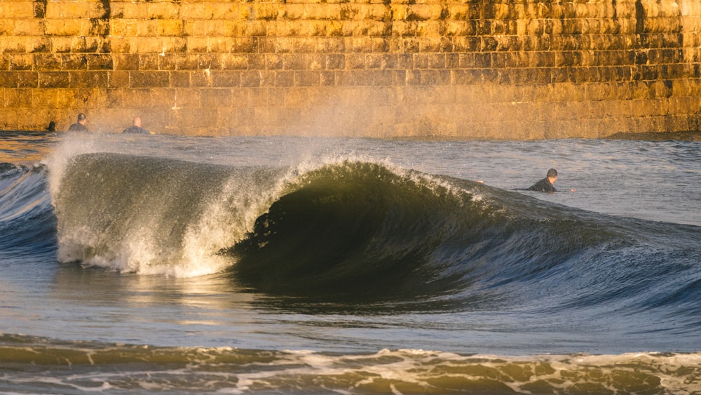 a person riding a wave on top of a surfboard