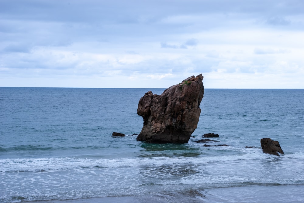 a large rock sticking out of the ocean