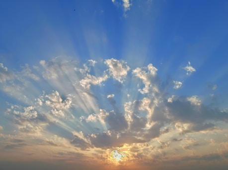 the sun is shining through the clouds in the sky