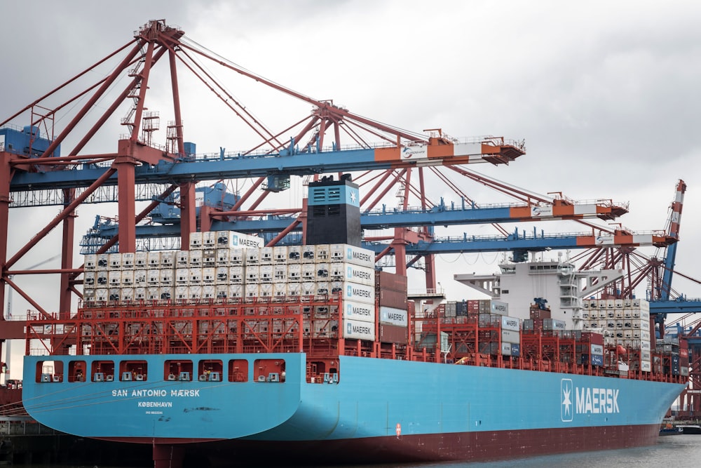 a large blue and red ship in the water