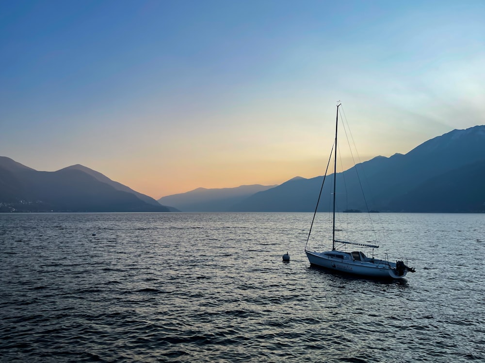 a sailboat floating in the middle of a body of water