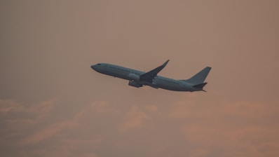 a large jetliner flying through a cloudy sky