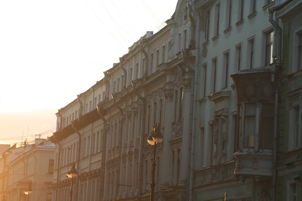 a row of buildings in a city at sunset