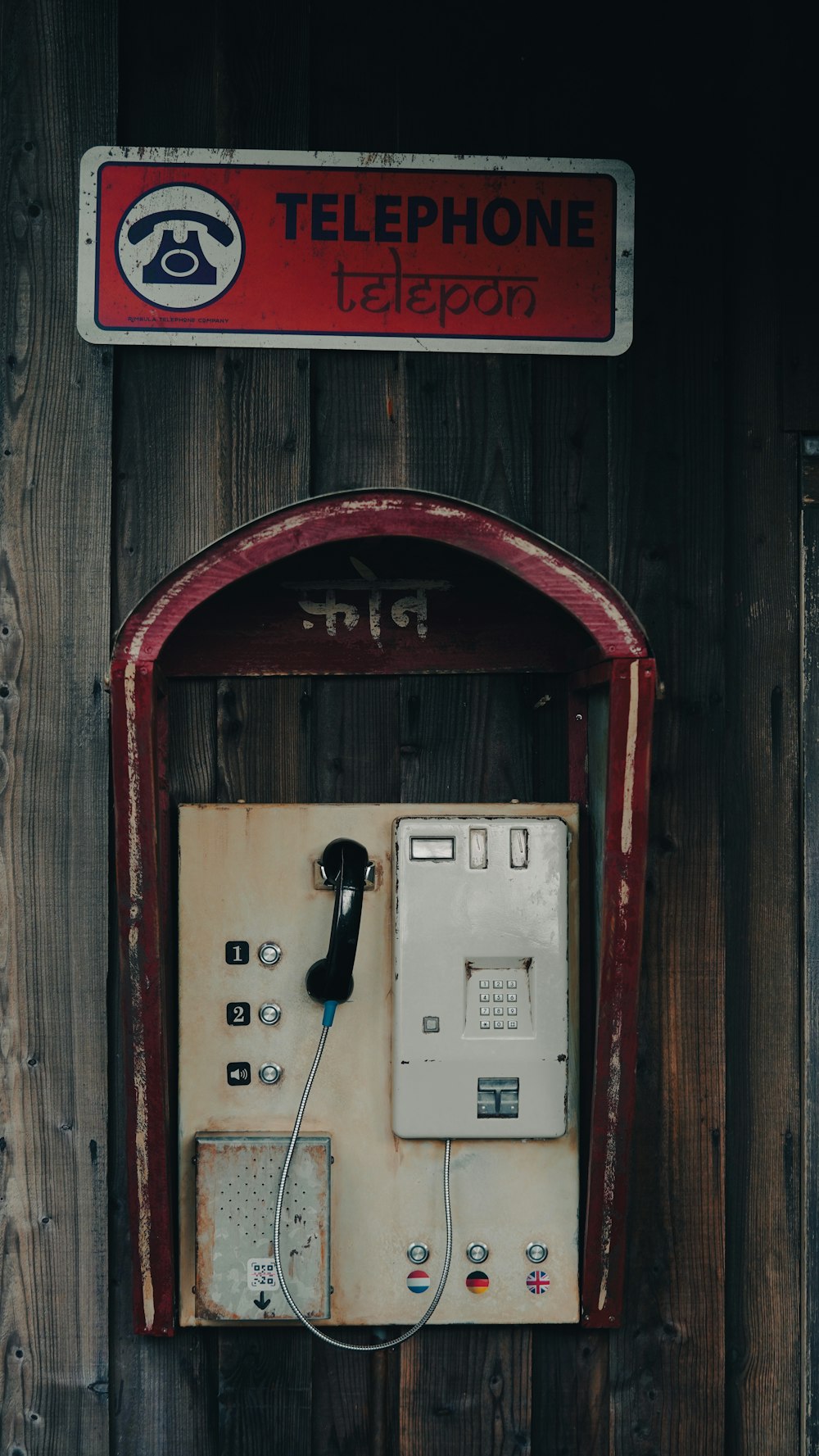 an old phone booth with a telephone on it