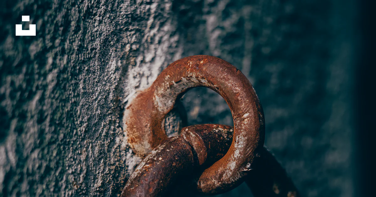 A rusted metal ring on the side of a wall photo – Free Rust Image on ...