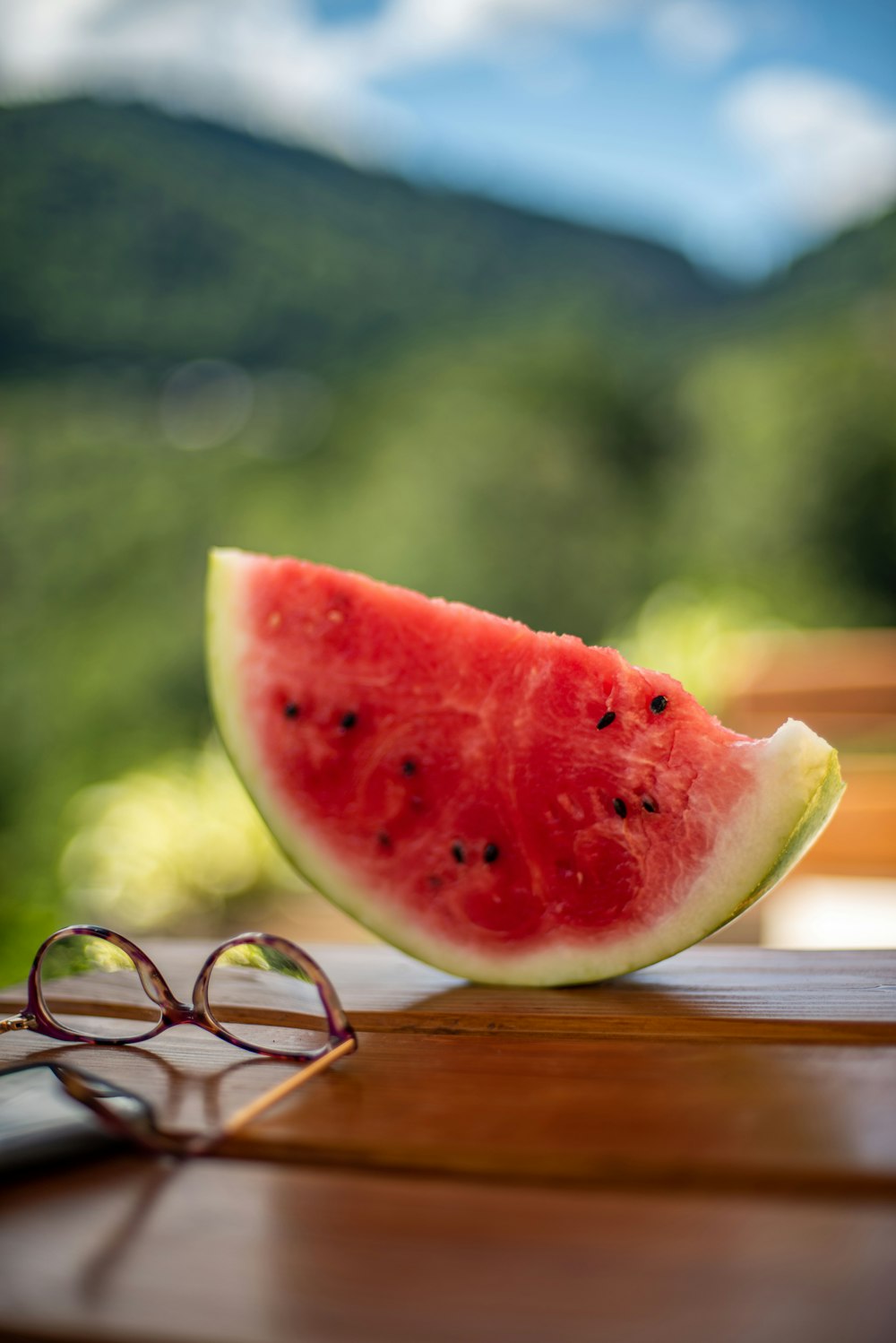 a slice of watermelon sitting on top of a wooden table