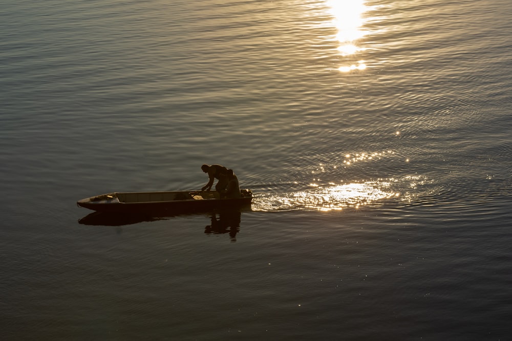 a person in a small boat on a body of water