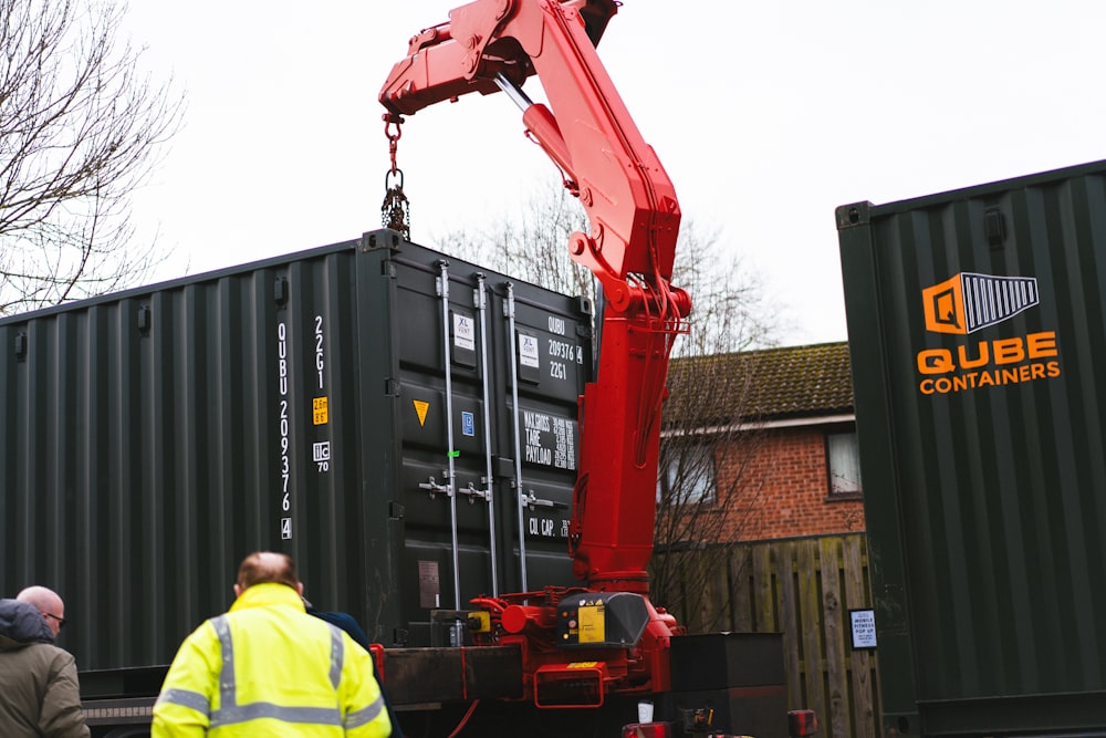 a crane is lifting a shipping container onto a truck