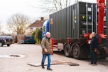 a couple of men standing next to a truck