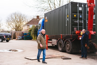 a couple of men standing next to a truck