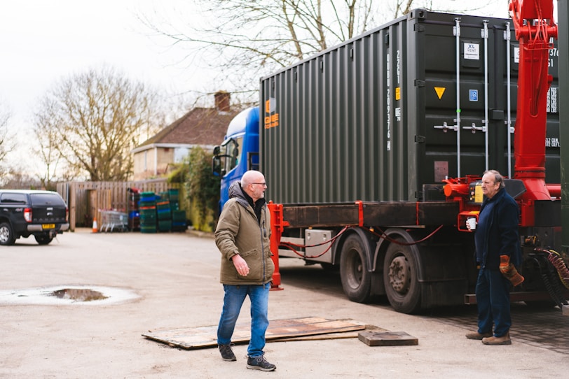 a couple of men standing next to a truck
