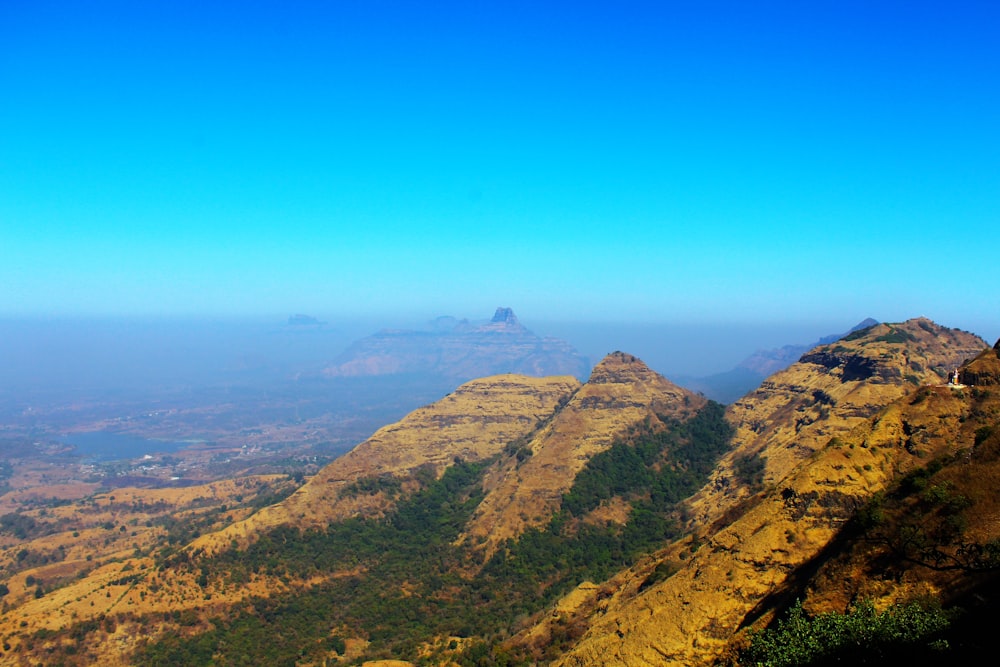 a view of a mountain range with a blue sky in the background