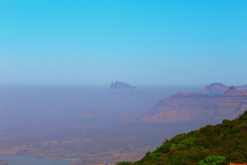 a view of a mountain range with a body of water in the distance