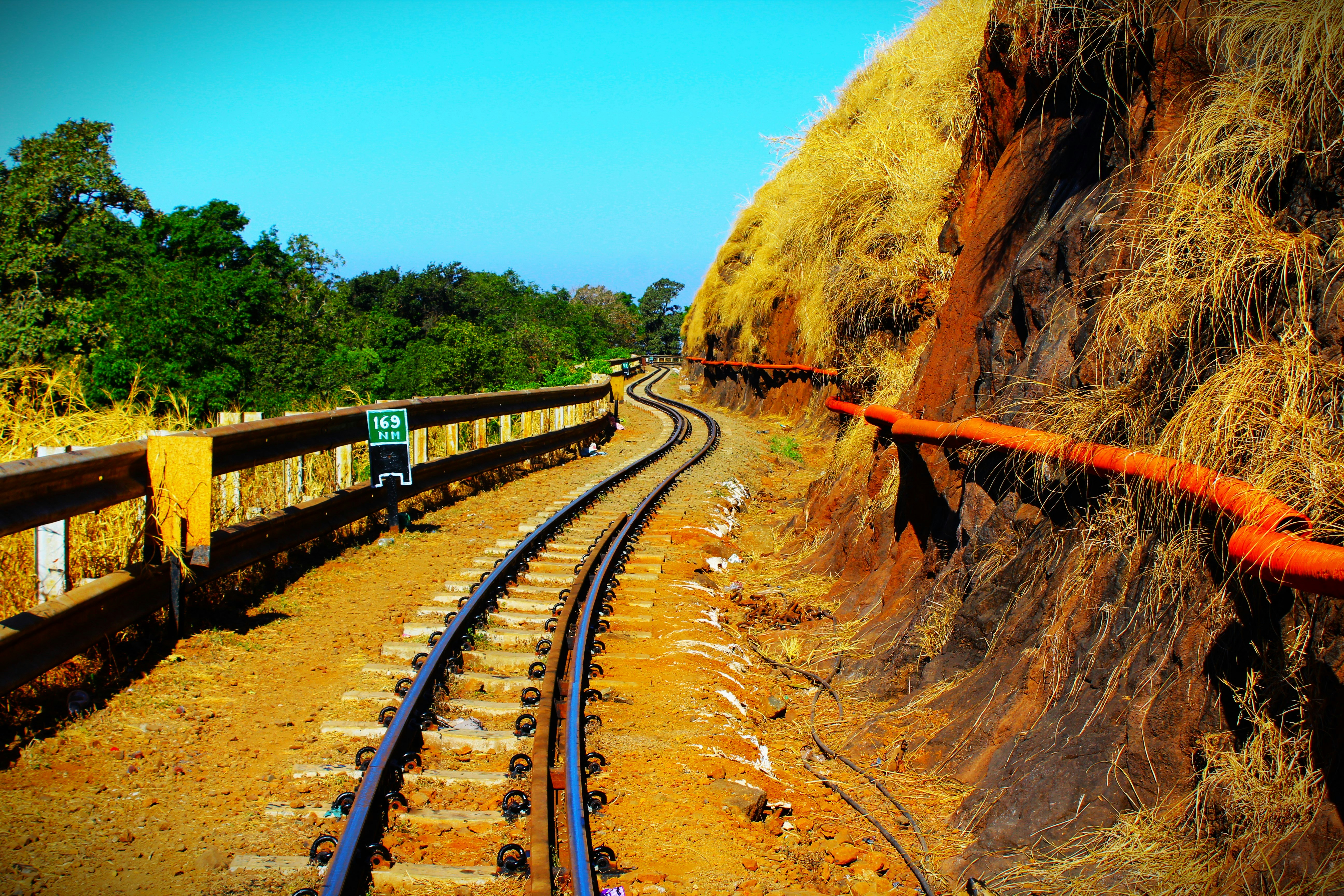 a view of a train track next to a cliff