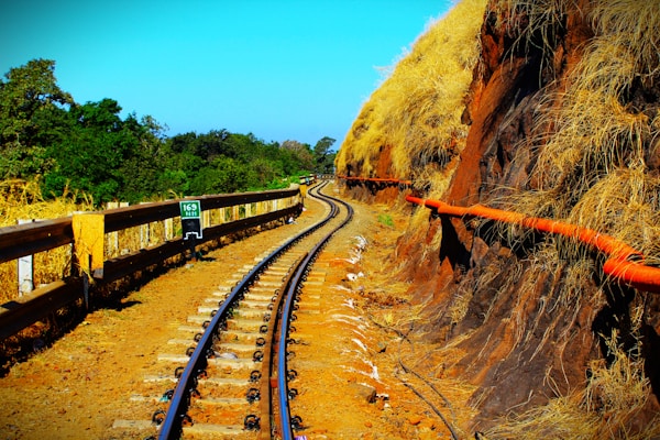 a view of a train track next to a cliff