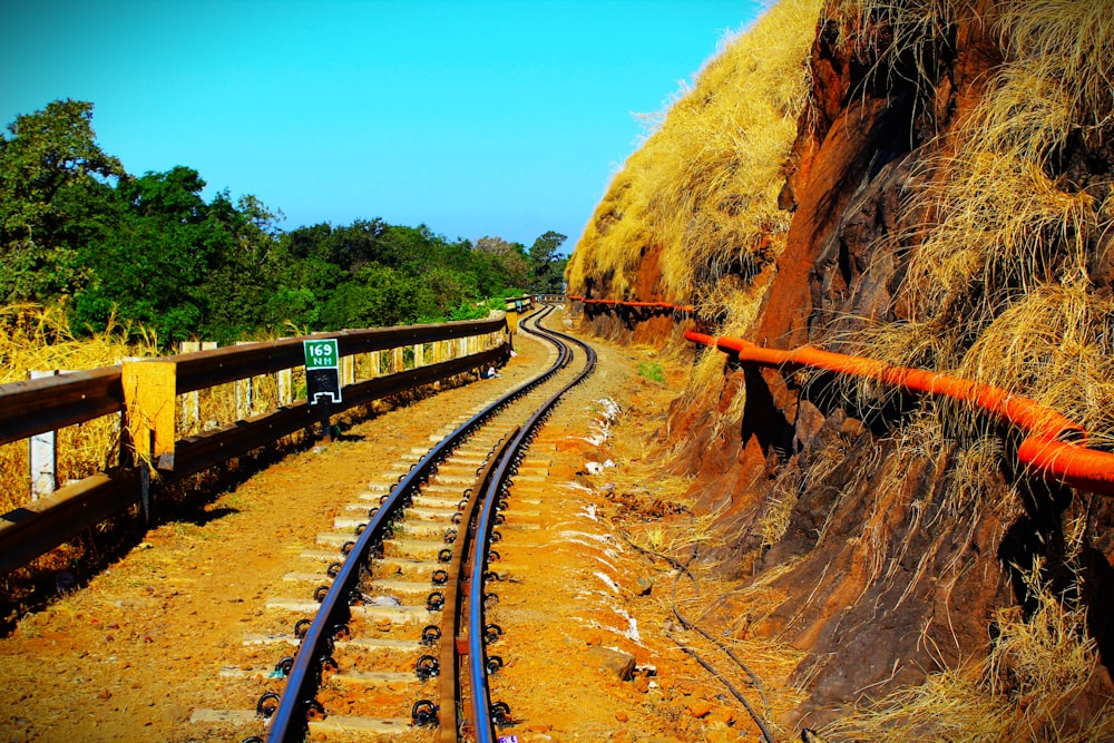 a view of a train track next to a cliff