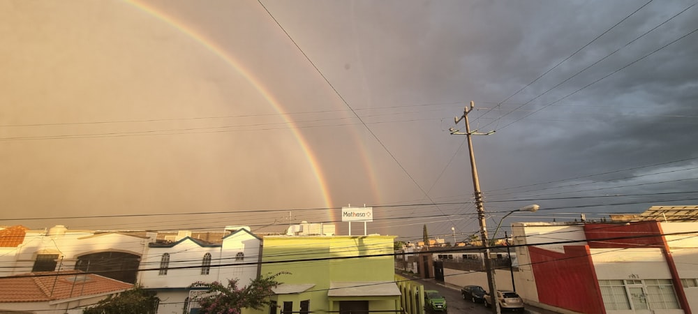 a double rainbow is seen over a neighborhood