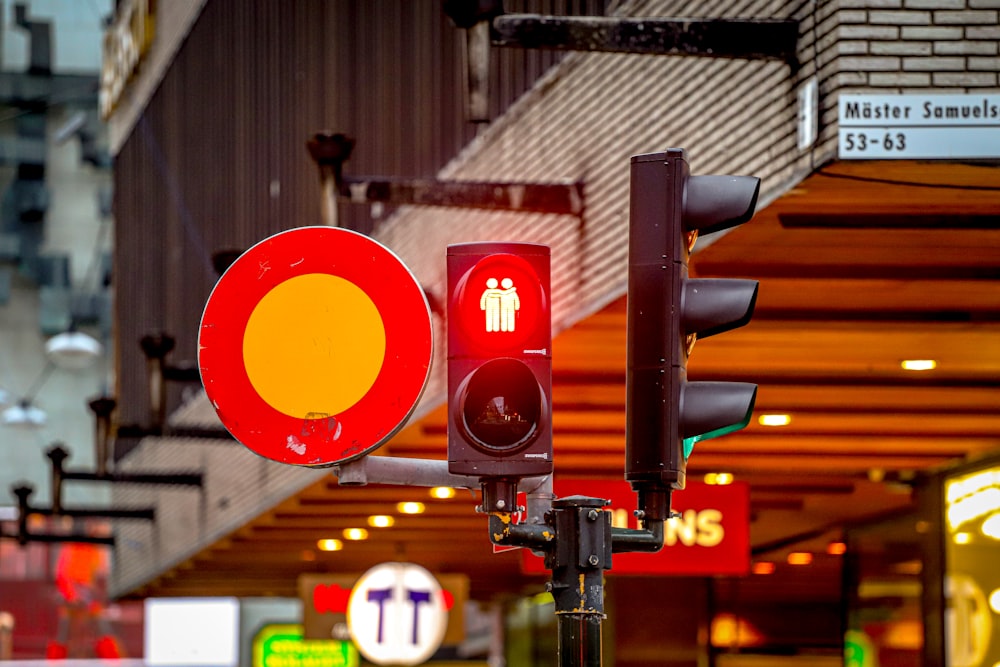 a red and yellow traffic light sitting on the side of a road