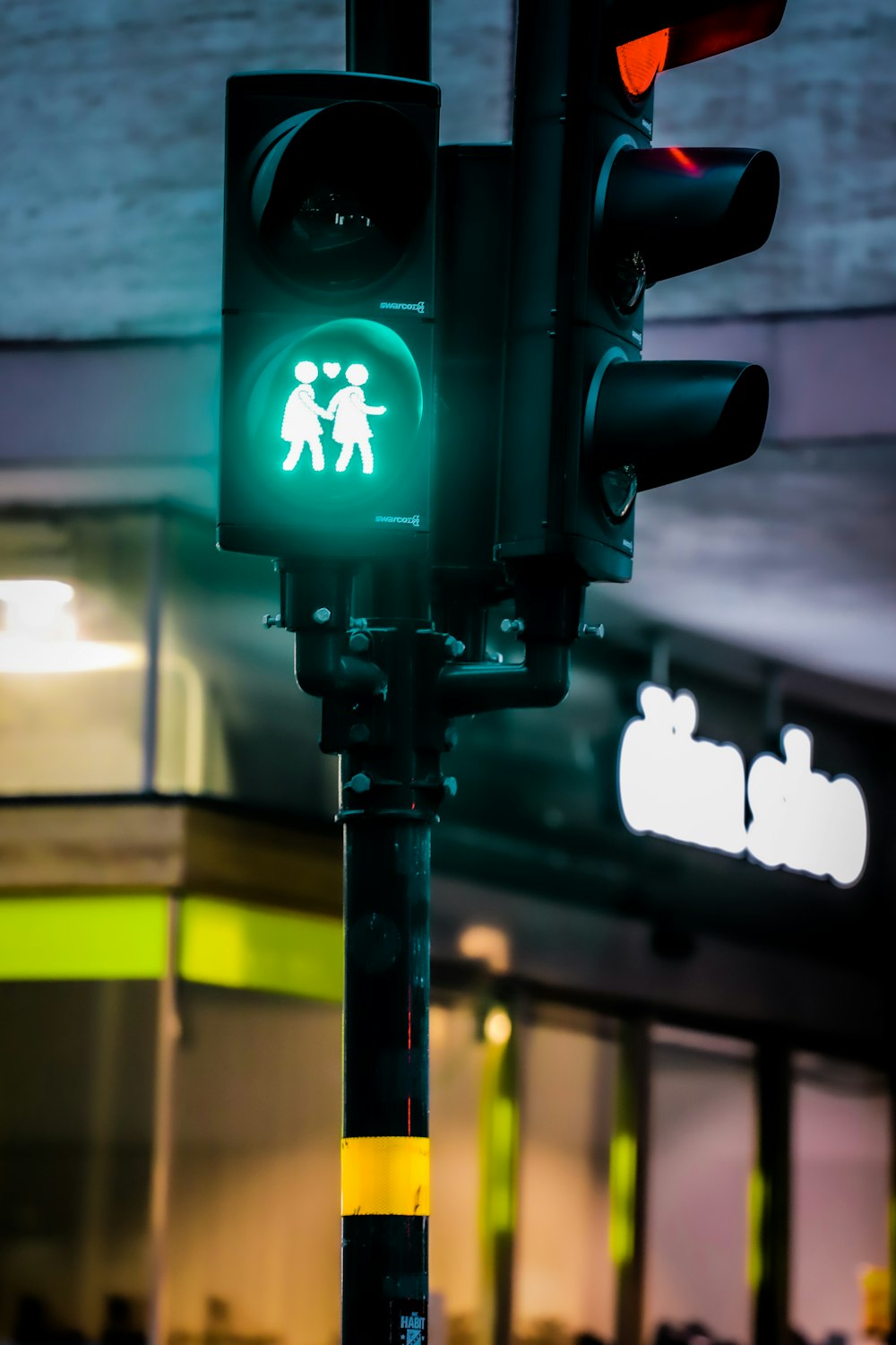 a green traffic light with a walk sign on it