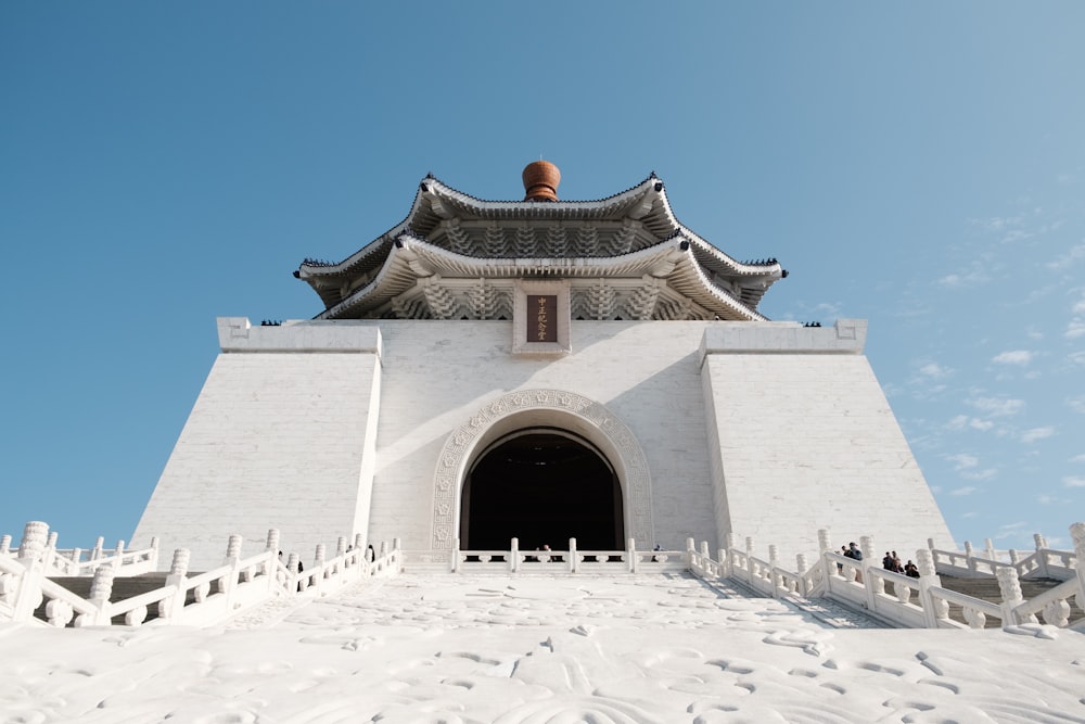 a tall white building with a sky background