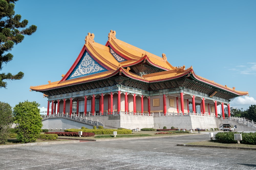 a large building with a yellow roof and red trim