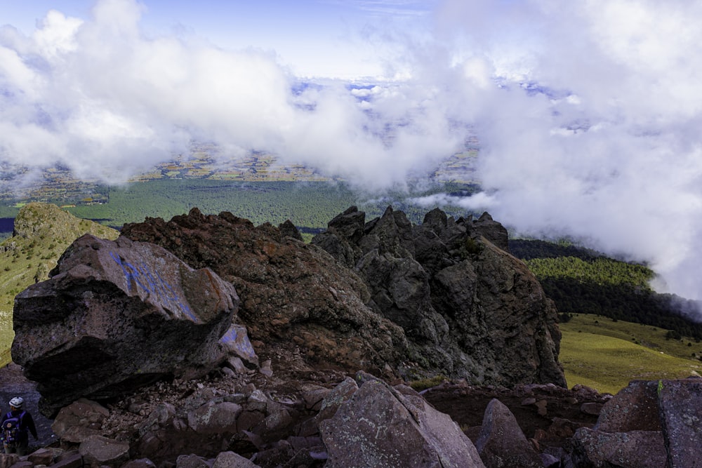 a man standing on top of a rocky mountain