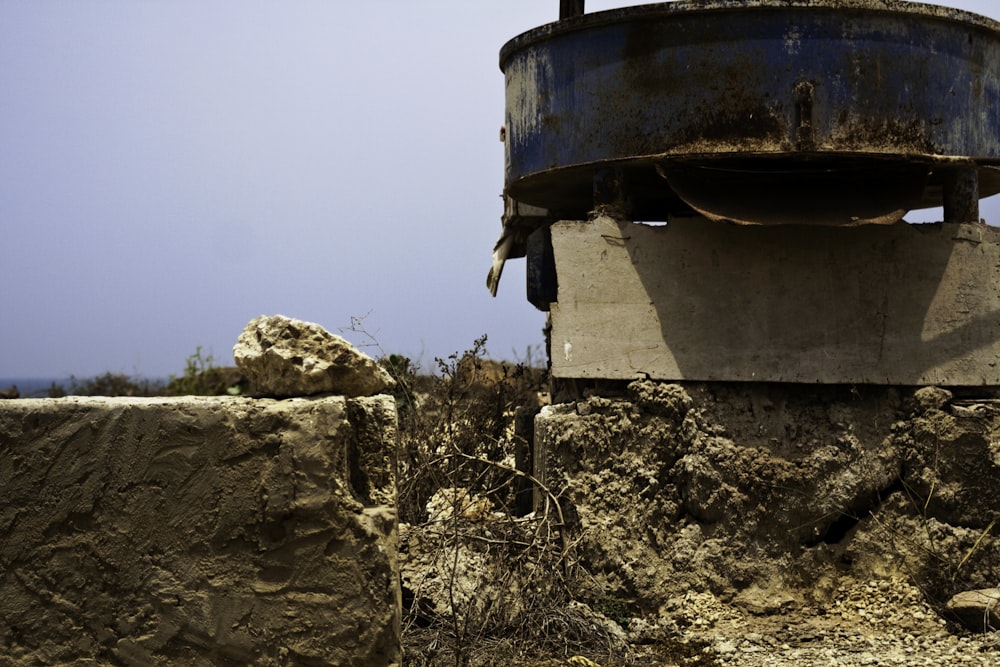 a large metal bucket sitting on top of a pile of dirt