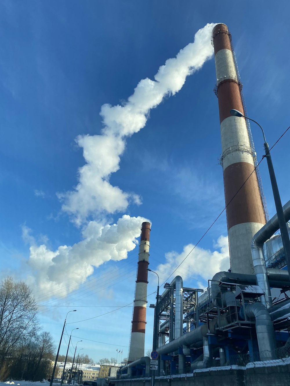 a factory with smoke coming out of it's stacks