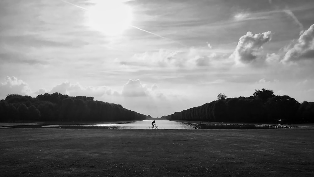 a black and white photo of a person in a field