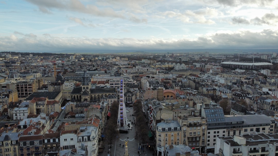 an aerial view of a city with tall buildings, Reims France