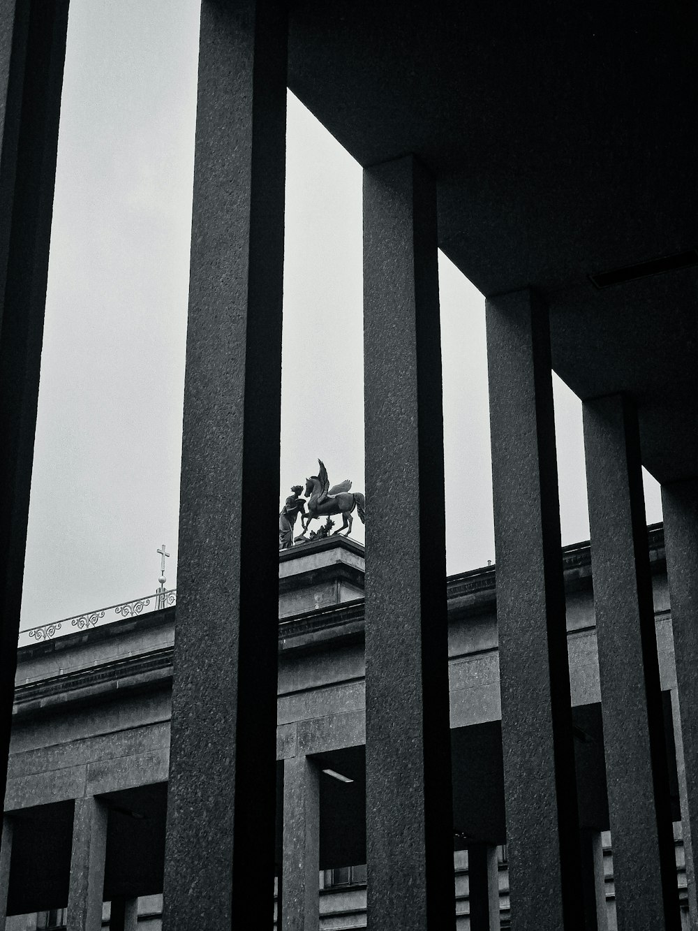 a black and white photo of a horse and carriage on a building