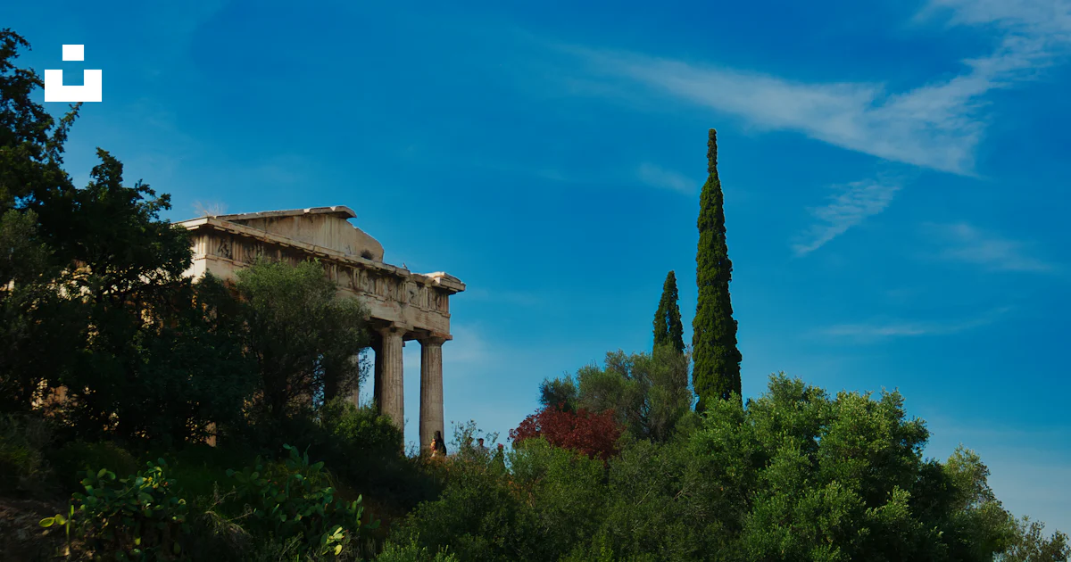 Agora Tree A building with columns and trees in front of a blue sky photo – Free ...