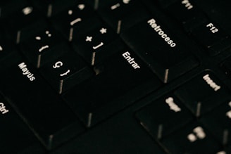 a close up of a black keyboard with white letters