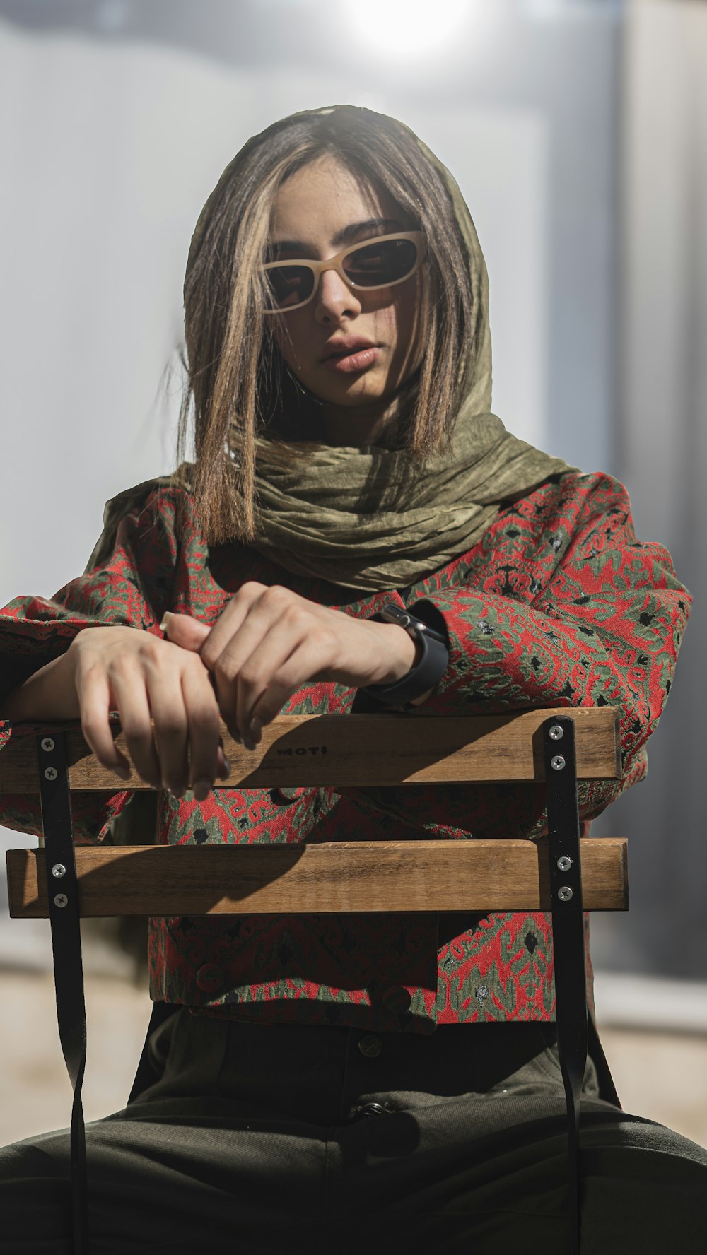 a woman sitting on top of a wooden bench