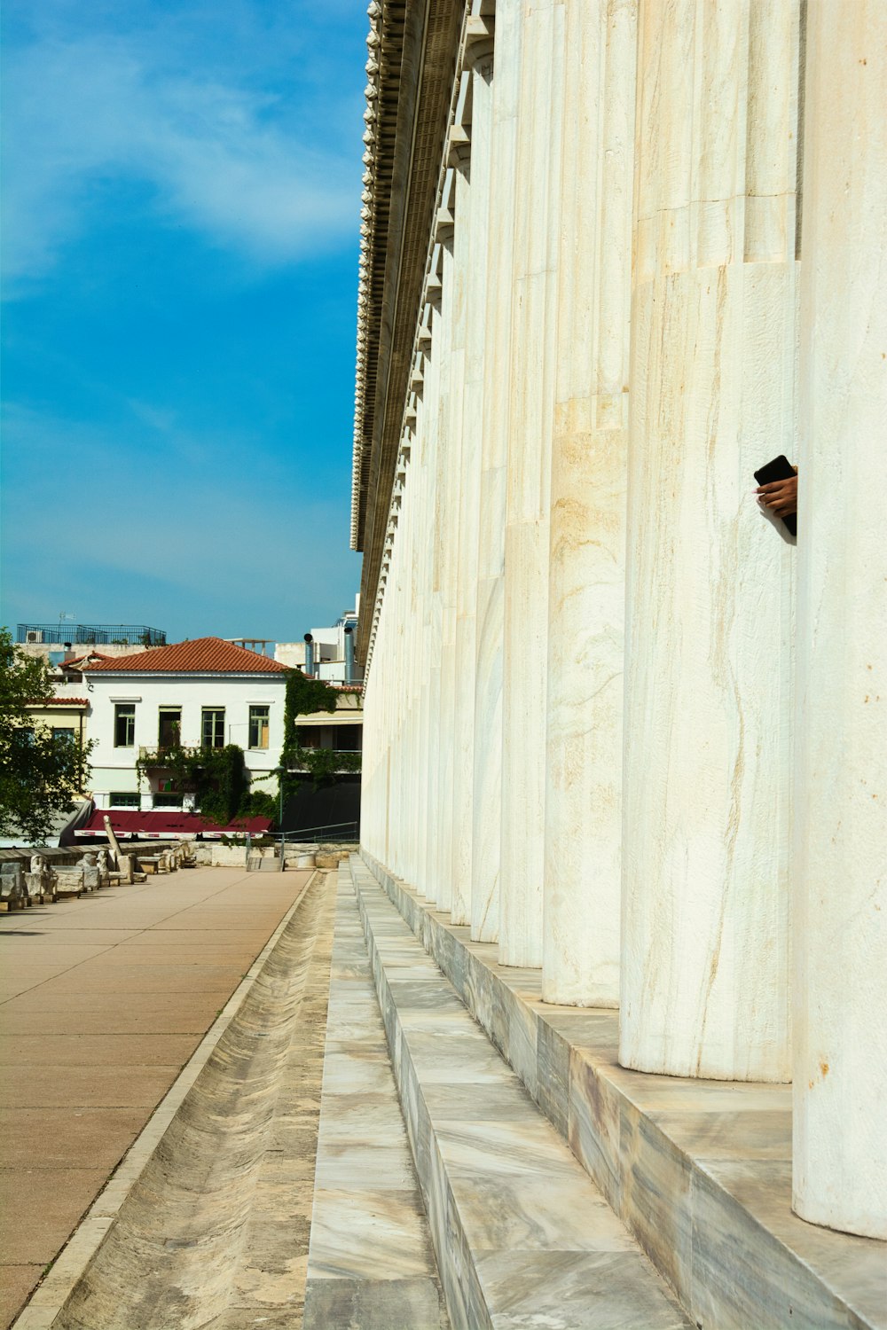 a white building with a clock on the side of it