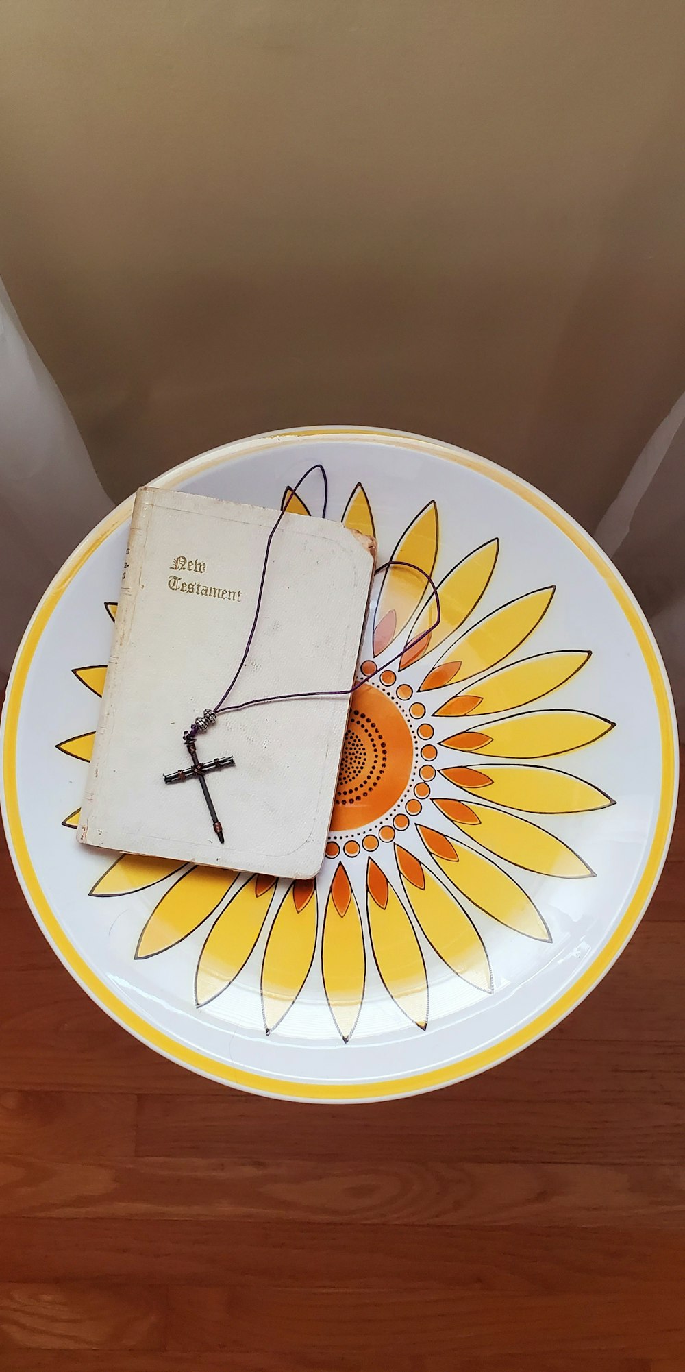 a yellow and white plate with a book on it