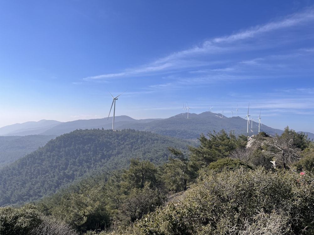 a view of a mountain with wind mills in the distance