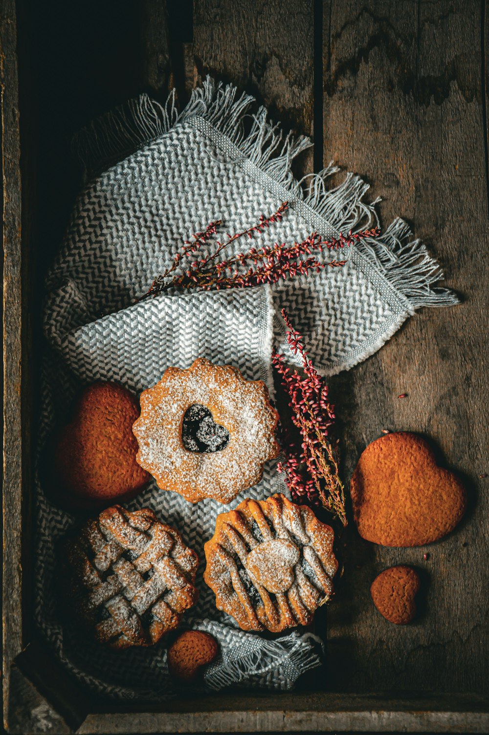 a box filled with pastries sitting on top of a wooden table