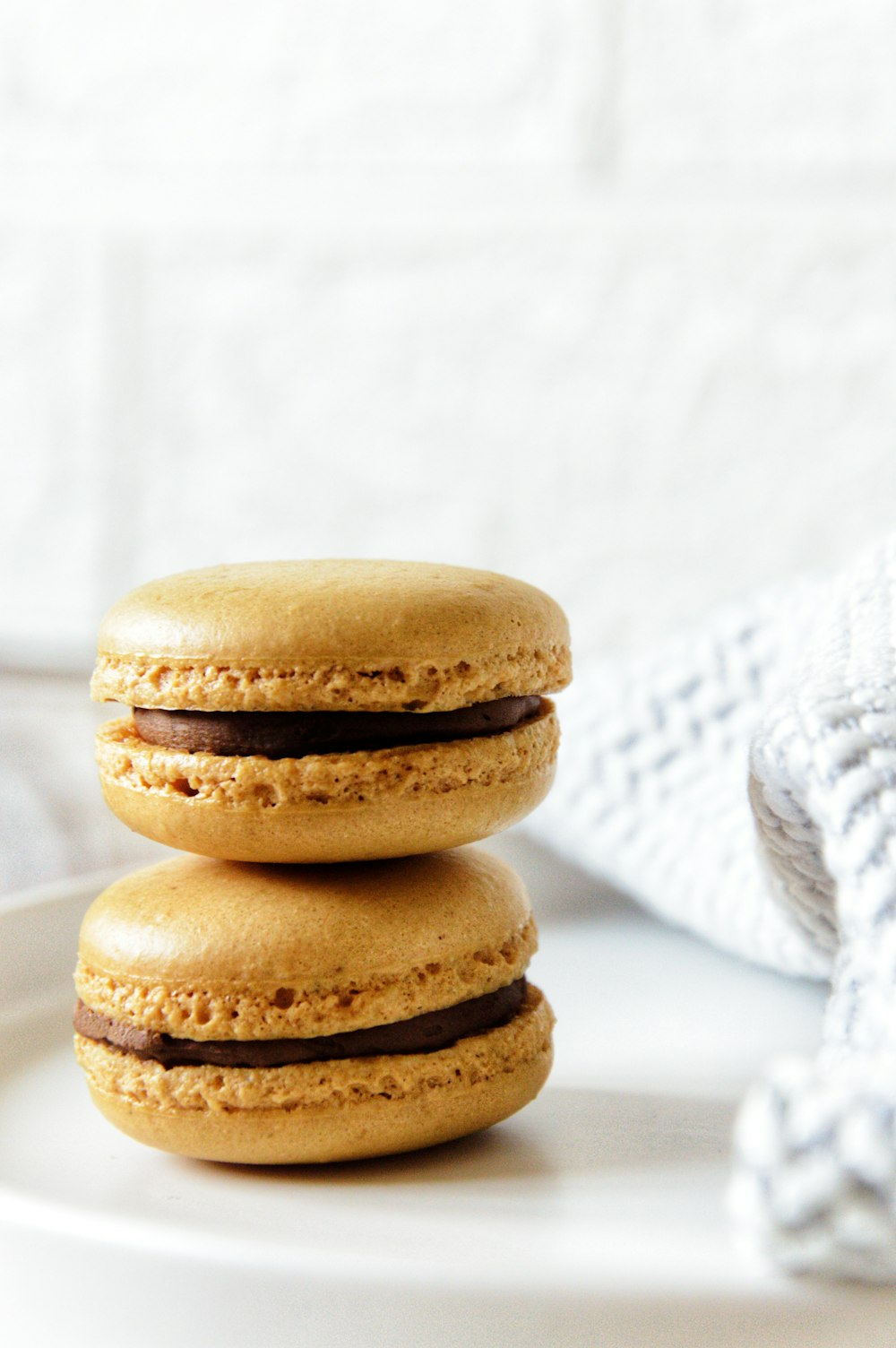 a stack of three cookies sitting on top of a white plate