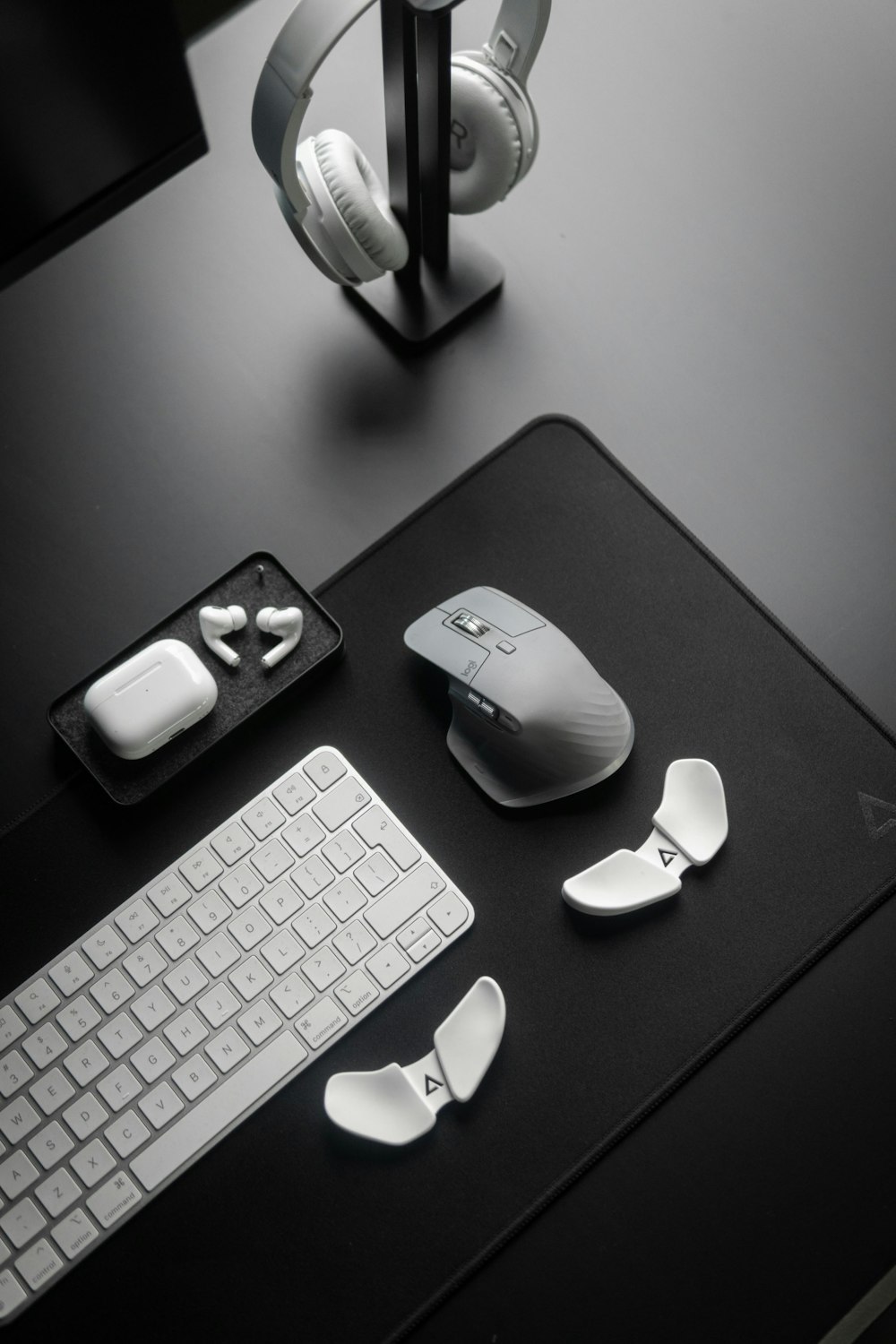 a computer desk with a keyboard, mouse and headphones