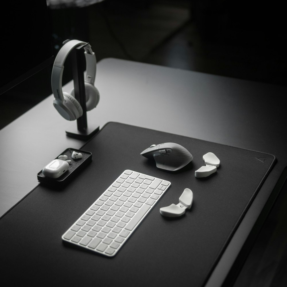 a computer desk with a keyboard, mouse and headphones