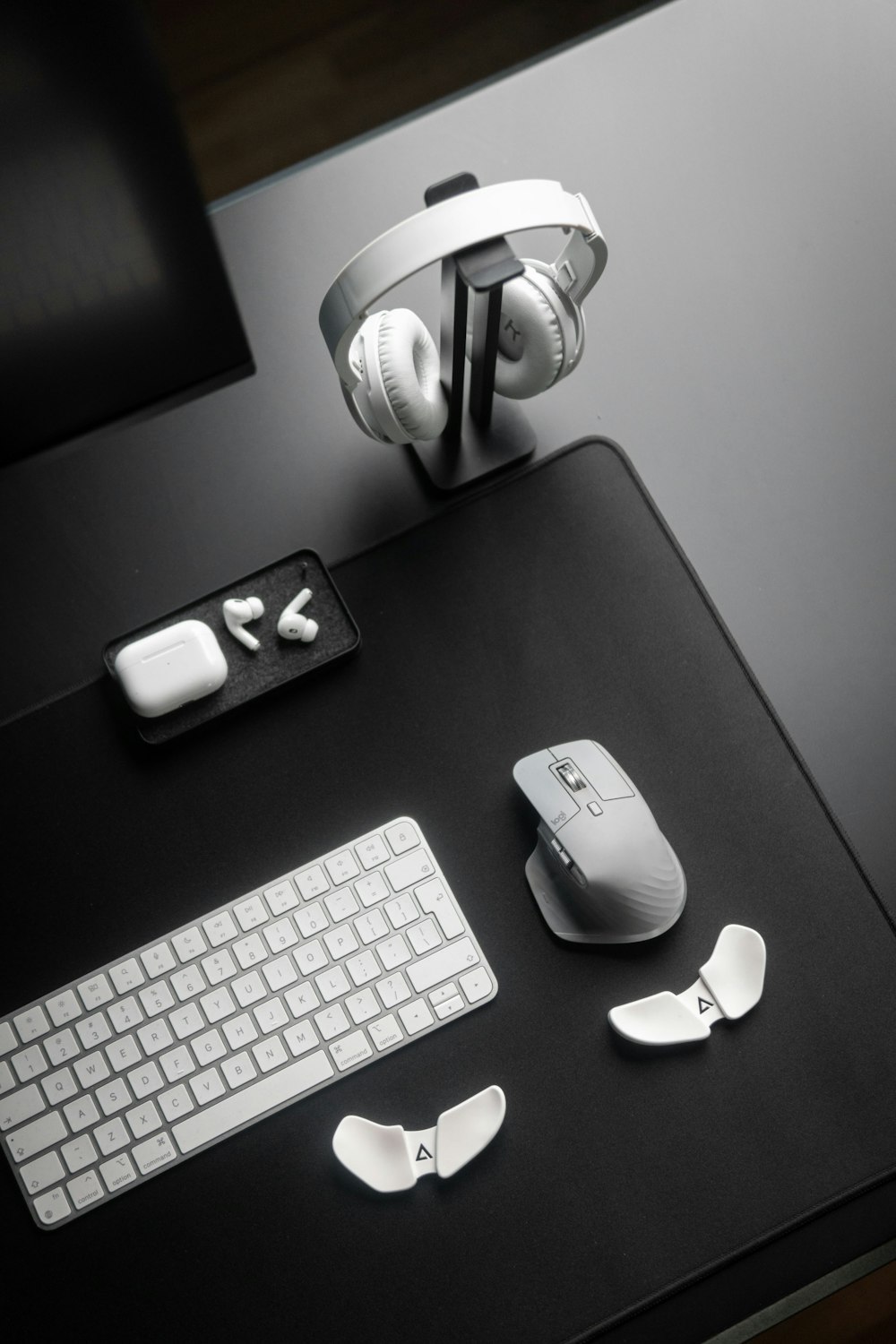 a desk with a keyboard, mouse and headphones