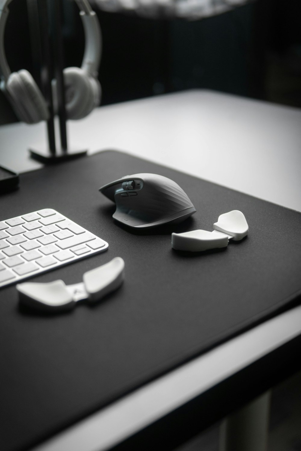 a computer desk with a keyboard, mouse and headphones