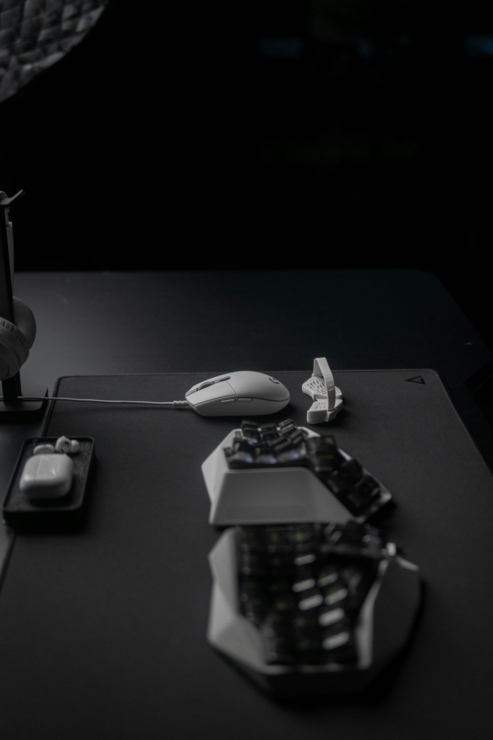 a desk with a computer mouse, keyboard and other items