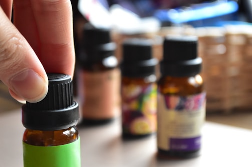 a hand touching a bottle of essential oils
