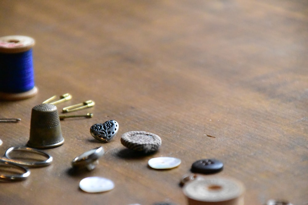 a wooden table topped with lots of sewing supplies