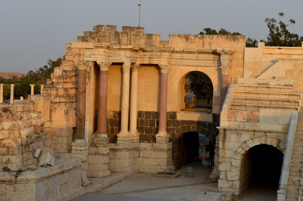 an old building with columns and a flag on top of it