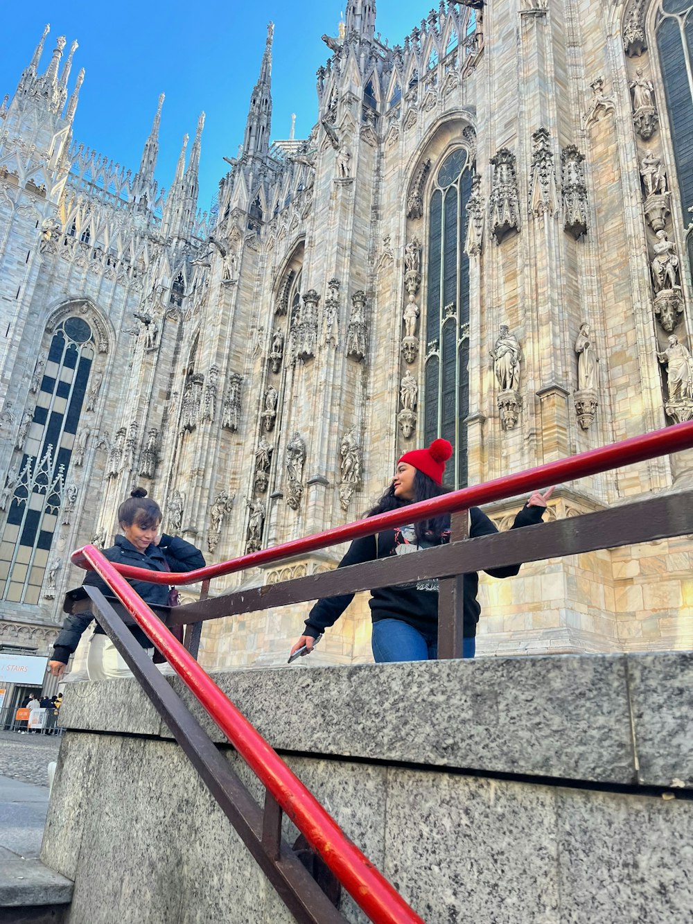 a couple of people that are standing on some stairs